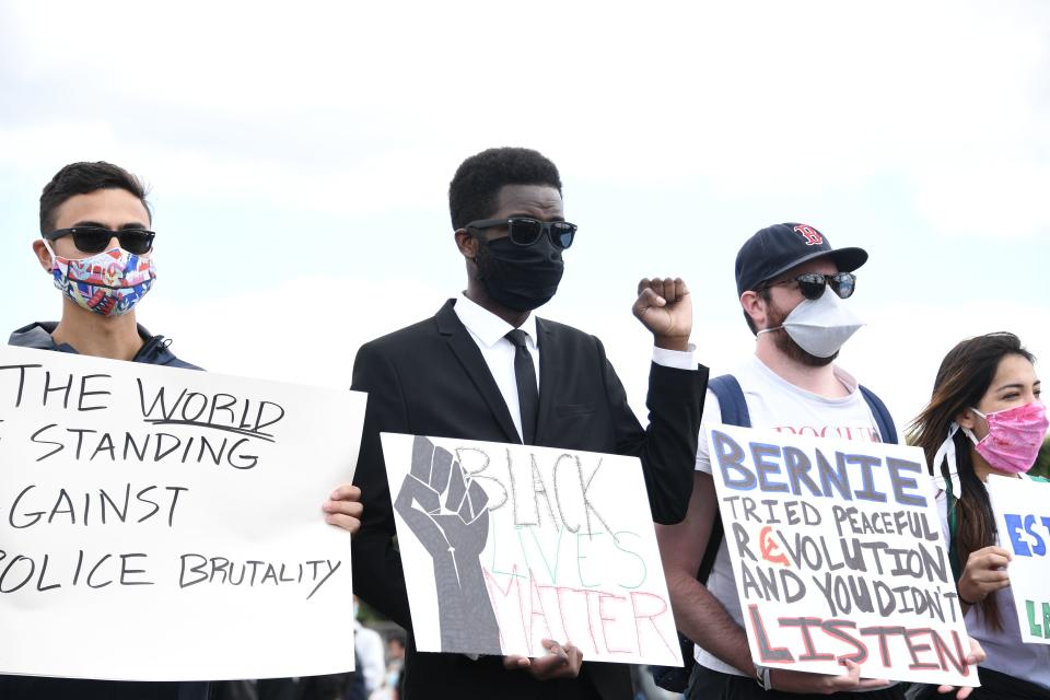 People with placards reading 'Black Lives Matter' gather on the place de la Concorde, near the US embassy compound, in Paris on June 6, 2020, during a rally called as part of a weekend of global rallies worldwide against racism and police brutality in the wake of the death of George Floyd, an unarmed black man killed while apprehended by police in Minneapolis, US. - Police banned the rally as well as a similar second one on the Champs de Mars park facing the Eiffel Tower today, saying the events were organised via social networks without official notice or consultation. But on June 2, another banned rally in Paris drew more than 20000 people in support of the family of Adama Traore, a young black man who died in police custody in 2016. (Photo by Anne-Christine POUJOULAT / AFP) (Photo by ANNE-CHRISTINE POUJOULAT/AFP via Getty Images)