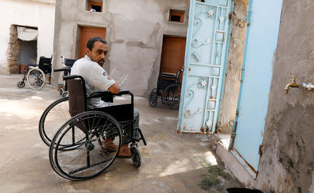 Hamid, 28, an unemployed member of a family of six disabled people, sits on a wheelchair at his house in Remada town south Tunisia, October 12, 2018. Picture taken October 12, 2018. REUTERS/Zoubeir Souissi