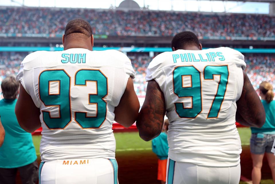 <p>Ndamukong Suh #93 and Jordan Phillups #97 of the Miami Dolphins stand for a moment of silences for Miami Marlins Pitcher Jose Fernandez prior to a game aagainst the Cleveland Browns on September 25, 2016 in Miami Gardens, Florida. Fernandez was killed in a boating accident early this morning. (Photo by Marc Serota/Getty Images) </p>