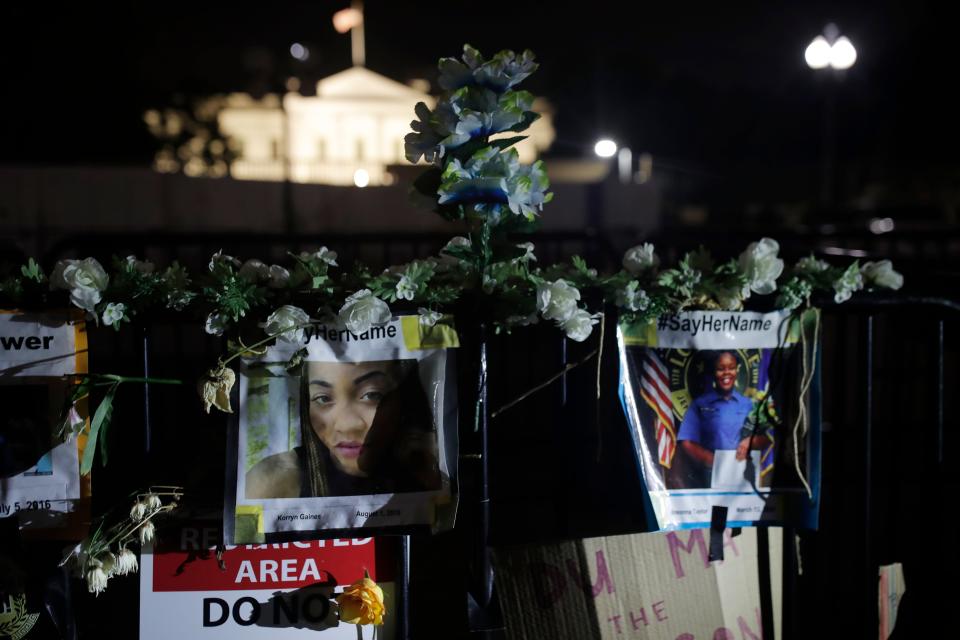 Photos of Korryn Gaines and Breonna Taylor, two Black women killed by police, are displayed in front of the White House in Washington, June 19, 2020, as people gathered here to mark Juneteenth, the holiday celebrating the day in 1865 that enslaved Black people in Galveston, Texas, learned they had been freed from bondage, more than two years after the Emancipation Proclamation.