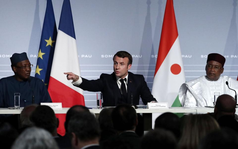 French President Emmanuel Macron (C) flanked by Niger's President in a press conference earlier this week - AFP