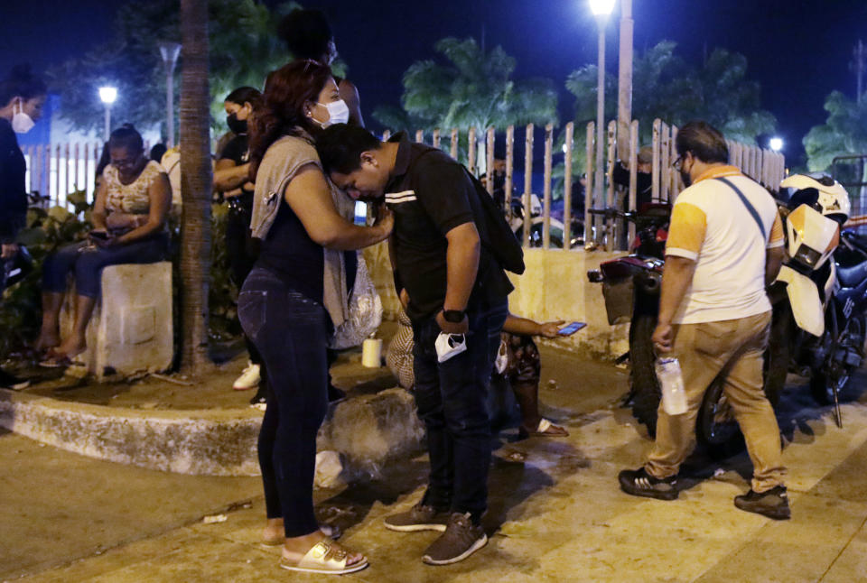 A woman comforts a man outside the morgue while waiting for the bodies of inmates killed in a riot at the Litoral penitentiary in Guayaquil, Ecuador, Wednesday, September 29, 2021. President Guillermo Lasso said in a press conference that the dead are so far 116. (AP Photo/Angel DeJesus)