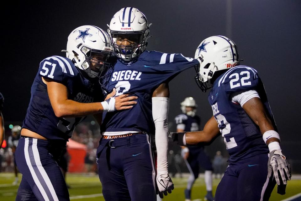 Siegel's Tarrion Grant (8) celebrates his touchdown against Oakland with Will Millican (51) and Christian Fletcher (22) during the second quarter at Siegel High School in Murfreesboro, Tenn., Thursday, Sept. 28, 2023.