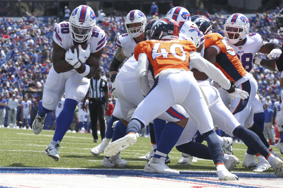 Buffalo Bills' Zack Moss, left, scores a touchdown during the first half of a preseason NFL football game against the Denver Broncos, Saturday, Aug. 20, 2022, in Orchard Park, N.Y. (AP Photo/Joshua Bessex)