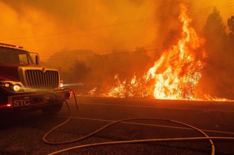 The Thompson fire flares up along Canyon Road in Oroville, California on Tuesday. Photo by Peter DaSilva/UPI