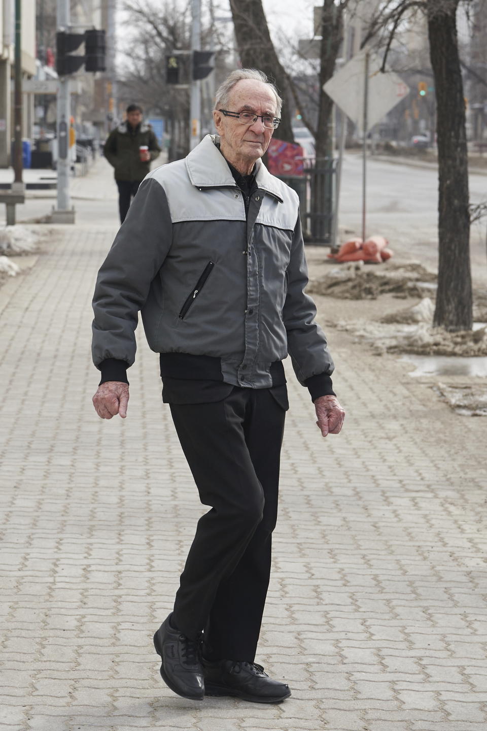 Retired priest Arthur Masse, 93, leaves the Law Courts in Winnipeg, Thursday, March 30, 2023 after a judge acquitted him of forcing himself on a residential school student more than 50 years ago, saying she believes an assault happened but could not determine beyond a reasonable doubt who did it. (David Lipnowski /The Canadian Press via AP)