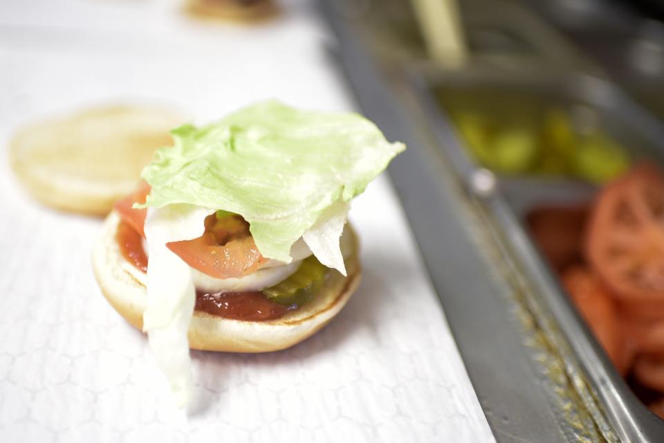 An American-style burger is prepared at Burger Boys on Chapman Highway in South Knoxville, Tenn. on Tuesday, July 20, 2021. The two-person operation serves up an assortment of fresh, homemade burgers and foods like wings, gizzards and French fries.