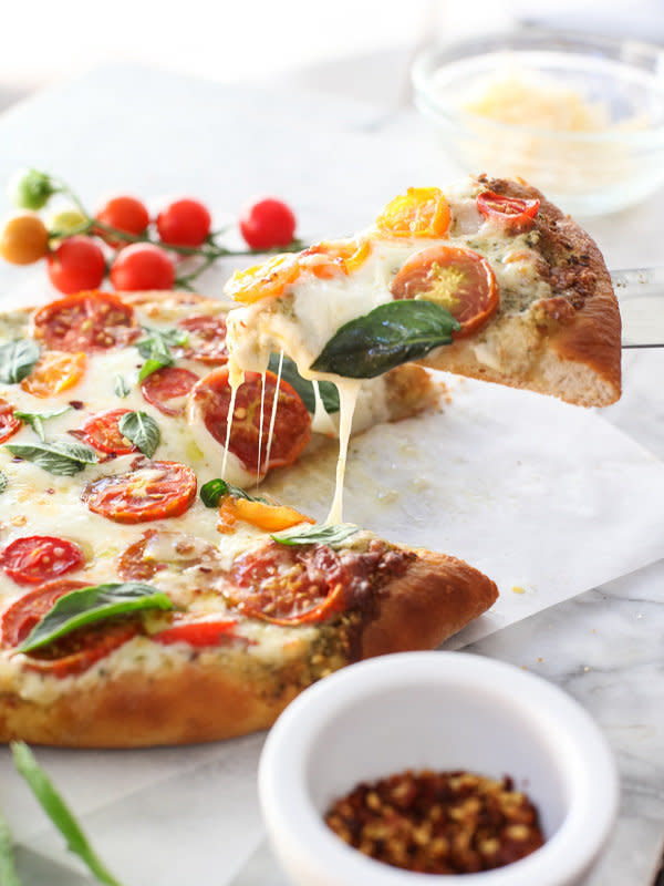 <strong>Get the <a href="http://www.foodiecrush.com/2014/08/pesto-pizza-with-fresh-tomatoes-and-mozzarella-and-perfect-pizza-at-home/" target="_blank">Pesto Pizza with Fresh Tomatoes and Mozzarella recipe</a> from Foodie Crush</strong>