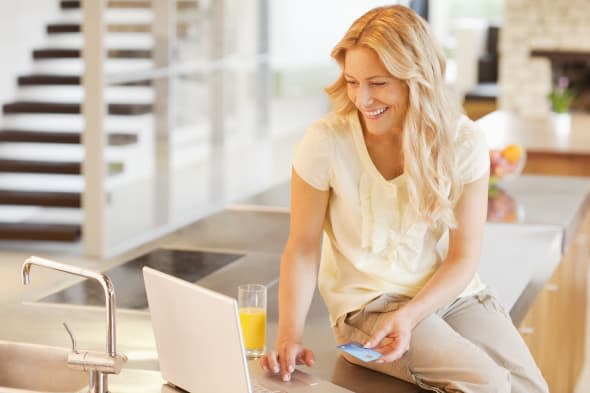 Woman shopping online with credit card