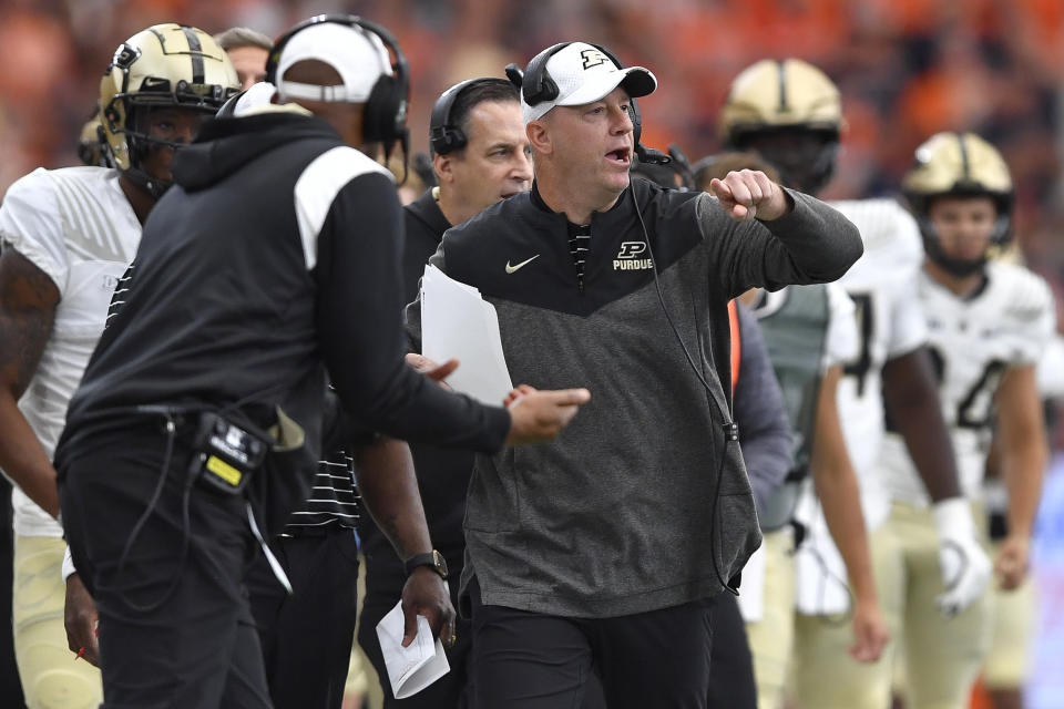 Purdue head coach Jeff Brohm, center, calls a play during the first half of an NCAA college football game against Syracuse in Syracuse, N.Y., Saturday, Sept. 17, 2022. (AP Photo/Adrian Kraus)