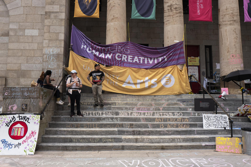 Signs and writing denouncing the closure of the University of the Arts are seen at Dorrance Hamilton Hall on Friday, June 14, 2024, in Philadelphia. The closure of the university has left some 1,300 students scrambling to find somewhere to go or something to do. (AP Photo/Joe Lamberti)