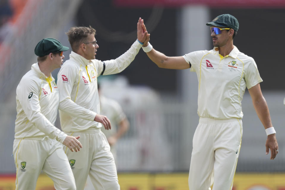 Australia's Todd Murphy, center, celebrates with teammates the dismissal of India's Ravindra Jadeja during the fourth day of the fourth cricket test match between India and Australia in Ahmedabad, India, Sunday, March 12, 2023. (AP Photo/Ajit Solanki)