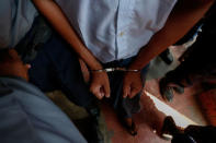 Detained Reuters journalist Wa Lone is escorted by police in handcuffs while arriving for a court hearing after a lunch break in Yangon, Myanmar February 21, 2018. REUTERS/Stringer