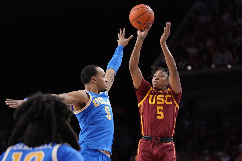 Southern California guard Boogie Ellis (5) shoots as UCLA guard Amari Bailey.