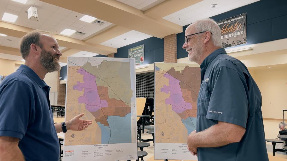 School Board district 3 representative Marc Dodd and Minneola Mayor Pat Kelley discuss new boundary maps at an East Ridge Middle School open house on May 20.