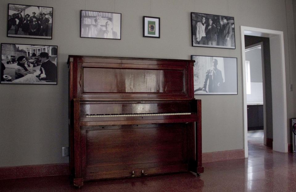 In this Aug. 1, 2013 photo, photographs about the life and films of Luis Bunuel hang at the "Casa Bunuel" in Mexico City. Despite that colorful legacy, Bunuel’s home is being presented as simply as the director left it, and not with the museum treatment given to the much-visited Mexico City abodes of Russian revolutionary Leon Trotsky and surrealist painter Frida Kahlo. (AP Photo/Gabriela Sanchez)