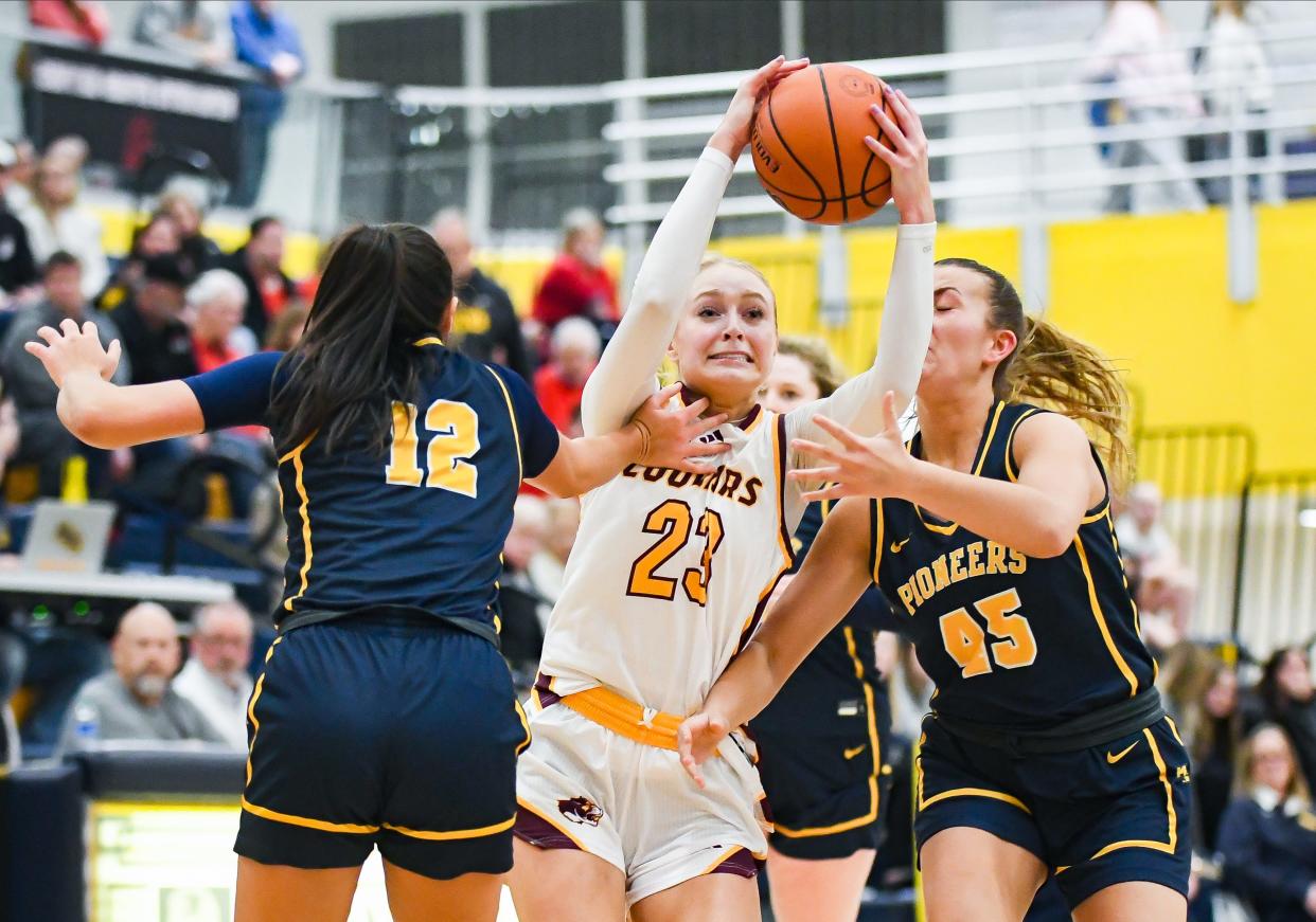 Bloomington North’s Mia Robbennolt (23) goes to the basket against Mooresville’s Addi VanWanzeele (12) and Kalyn Bunch (45) during the IHSAA semi-final sectional game at Mooresville High School on Friday, Feb. 2, 2024.