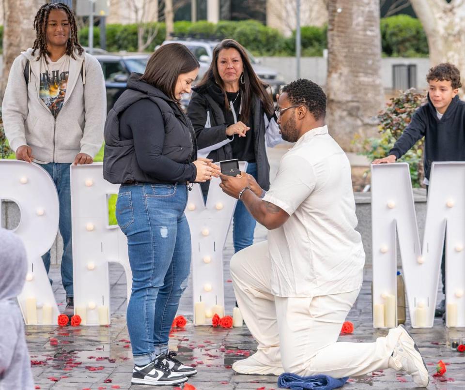 Jovontue Dorsett, 36, proposes to Shelby Ray, 31, at Capitol Park’s World Peace Rose Garden on Sunday, March 3, 2024.