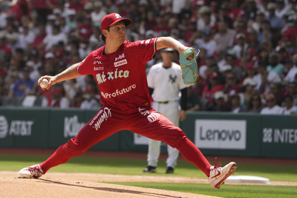 Diablos Rojos' pitcher Trevor Bauer throws against New York Yankees' Anthony Volpe during the first inning of a baseball exhibition game at Alfredo Harp Helu Stadium in Mexico City, Sunday, March 24, 2024. (AP Photo/Fernando Llano)