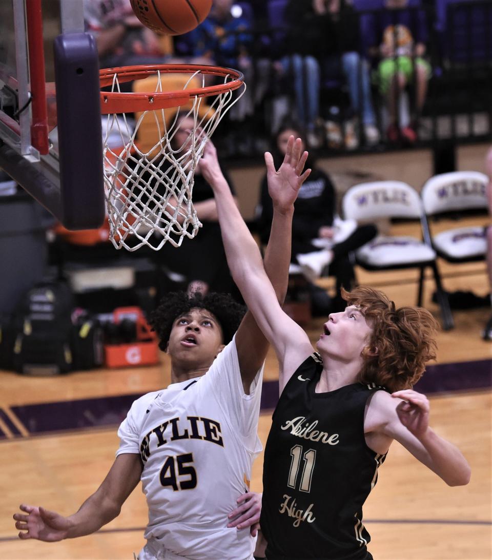 Abilene High's Connel Colley (11) battles Wylie's Quentin Whitted for a rebound in the second half. Wylie beat the Eagles 54-45 in the District 4-5A game Jan. 17 at Bulldog Gym.