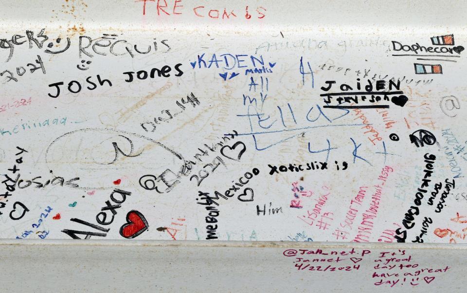 Detail from one of the last steel beams, signed by students and faculty members, to be attached on the new W.P. Grier Middle School Tuesday morning, April 23, 2024.