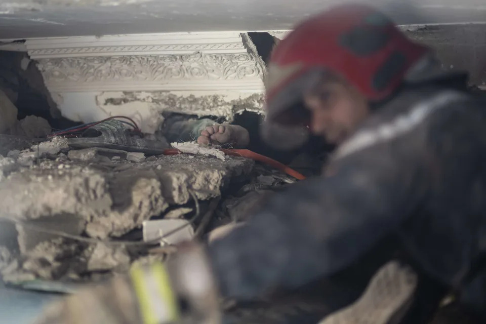 The foot of a man stuck under rubble while a rescue operation for him is underway, after an earthquake, in Moulay Brahim village, near Marrakech, Morocco, Saturday, Sept. 9, 2023. A rare, powerful earthquake struck Morocco late Friday night, killing more than 800 people and damaging buildings from villages in the Atlas Mountains to the historic city of Marrakech. But the full toll was not known as rescuers struggled to get through boulder-strewn roads to the remote mountain villages hit hardest. (AP Photo/Mosa'ab Elshamy)