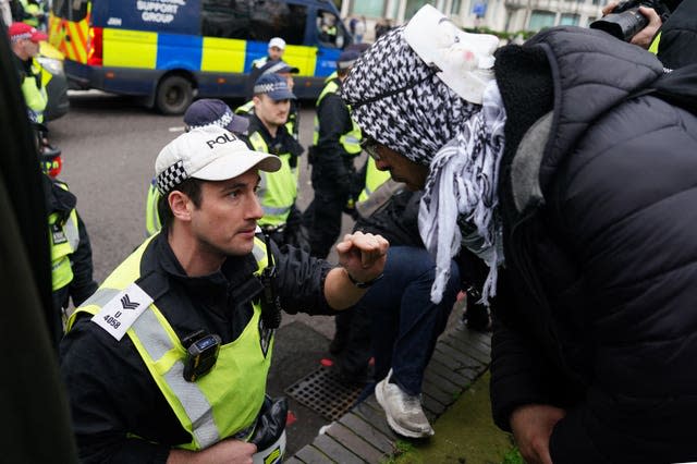 Police officer speaking to protester