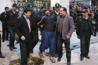 FILE - This Tuesday, April 15, 2014, file photo provided by ISNA, a semi-official news agency, shows blindfolded Iranian convicted man Bilal being escorted by officials and security to be prepared for his execution in public in the northern city of Nour, Iran. Bilal, who was convicted of killing Abdollah Hosseinzadeh, was pardoned by the victim's family moments before being executed. His mother, Samerah Alinejad tells The Associated Press that she had felt she could never live with herself if the man who killed her son were spared. But in the last moment, she pardoned him in an act that has made her a hero in her hometown, where banners in the streets praise her family’s mercy. (AP Photo/ISNA, Arash Khamoushi, File)