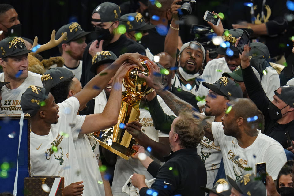 The Milwaukee Bucks celebrate with the championship trophy after defeating the Phoenix Suns in Game 6 of basketball's NBA Finals in Milwaukee, Tuesday, July 20, 2021. The Bucks won 105-98. (AP Photo/Paul Sancya)