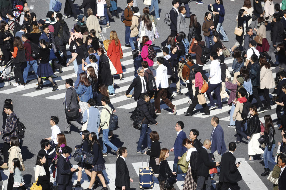 People cross a street in Tokyo, Thursday, Nov. 14, 2019. Japan’s economy grew at a modest annual pace of 0.2% in July-September, supported by consumer purchases ahead of a tax hike, the government said Thursday. (AP Photo/Koji Sasahara)