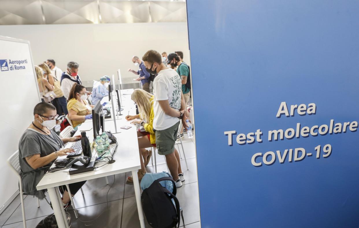 Passengers of a flight from Valencia, Spain wait to be tested for COVID-19 after disembarking at Rome's Ciampino airport on Aug. 19, 2020. Italy's health minister issued an ordinance requiring the tests for all travelers arriving in Italy from Croatia, Greece, Malta or Spain.