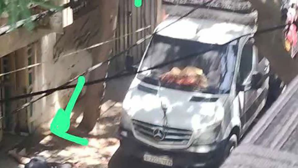 This Mercedes van, seen in an image taken from social media, was parked on a street in Nuseirat, Gaza, where the operation unfolded. Two ladders can be seen leaning up against a multistory building next to the van to reach an upper floor. - From social media