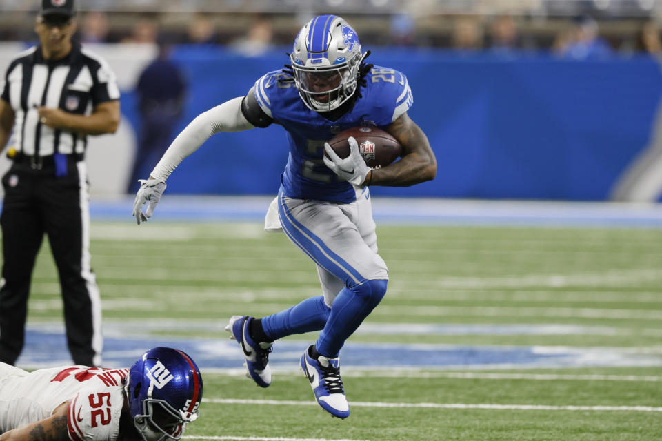 Detroit Lions running back Jahmyr Gibbs (26) outruns New York Giants linebacker Carter Coughlin (52) during the first half of an NFL preseason football game, Friday, Aug. 11, 2023, in Detroit. (AP Photo/Duane Burleson)