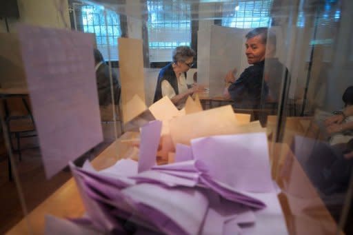 Women prepare their ballots at a polling station in Belgrade. Polls closed Sunday in Serbia's closely fought presidential and parliamentary elections that pitted pro-EU President Boris Tadic against nationalist Tomislav Nikolic amid grinding economic woes