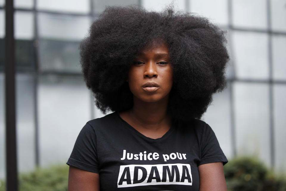 Assa Traore, wearing a shirt that reads: “Justice for Adama, without Justice you will never be in Peace,” attends an interview in Ivry-sur-Seine, on the outskirts of Paris, Wednesday, July 15, 2020. Traore started by fighting for justice for her brother Adama, who died in police custody on his 24th birthday four years ago. She’s now at the forefront of a new movement for Black rights in France that aims to wipe out systemic racism in policing and challenge the country’s official vision of itself as a colorblind society. (AP Photo/Francois Mori)