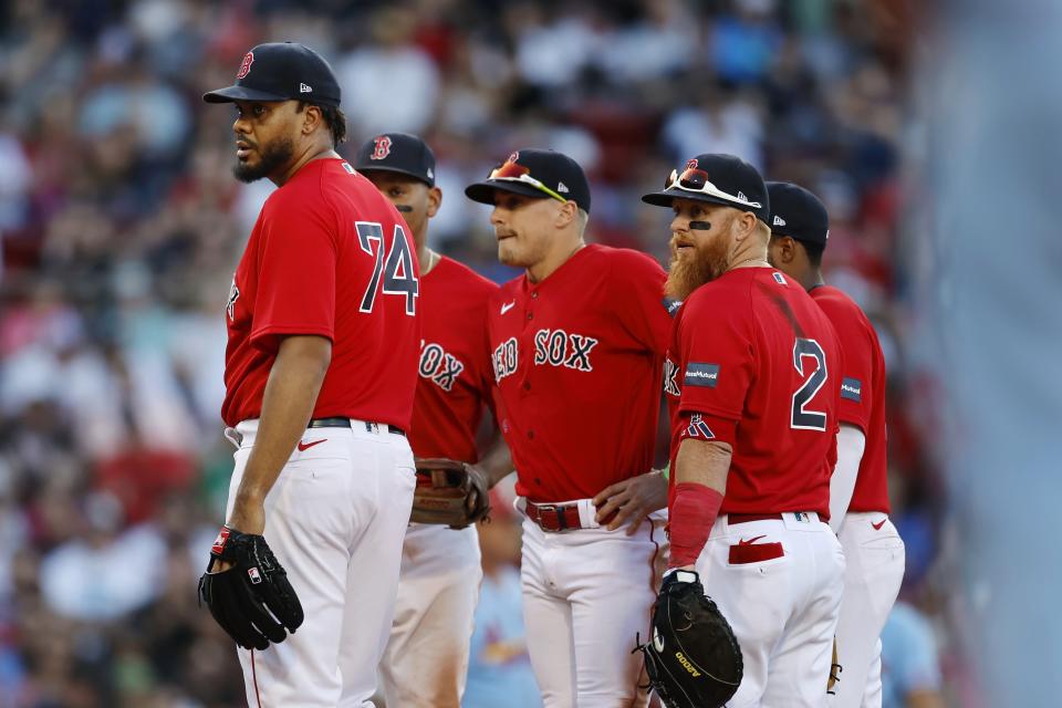 Boston Red Sox's Kenley Jansen (74) and his infield look to the dugout before intentionally walking St. Louis Cardinals' Brendan Donovan in the ninth inning of a baseball game, Saturday, May 13, 2023, in Boston. (AP Photo/Michael Dwyer)