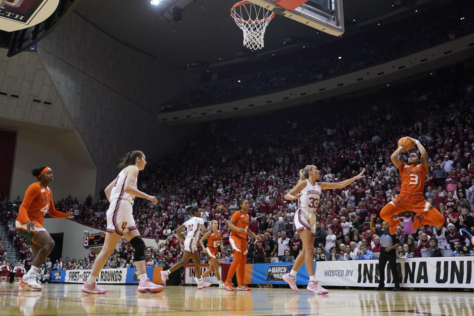 Miami's Destiny Harden (3) shoots against Indiana's Sydney Parrish (33) during the second half of a second-round college basketball game in the women's NCAA Tournament Monday, March 20, 2023, in Bloomington, Ind. (AP Photo/Darron Cummings)