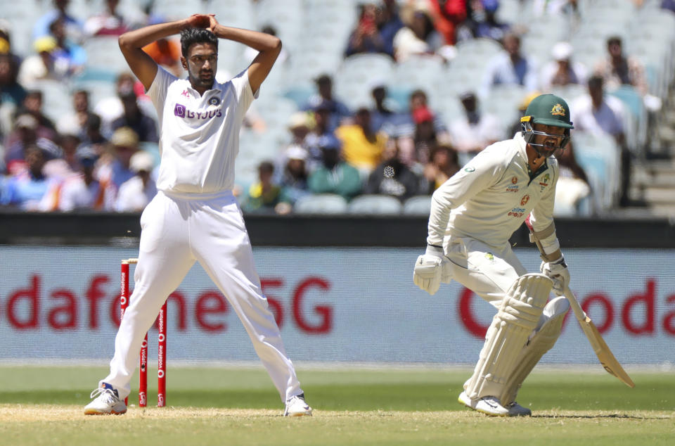 Indian bowler Ravichandran Ashwin, left, reacts as Australia's Nathan Lyon runs a single during play on day four of the second cricket test between India and Australia at the Melbourne Cricket Ground, Melbourne, Australia, Tuesday, Dec. 29, 2020. (AP Photo/Asanka Brendon Ratnayake)
