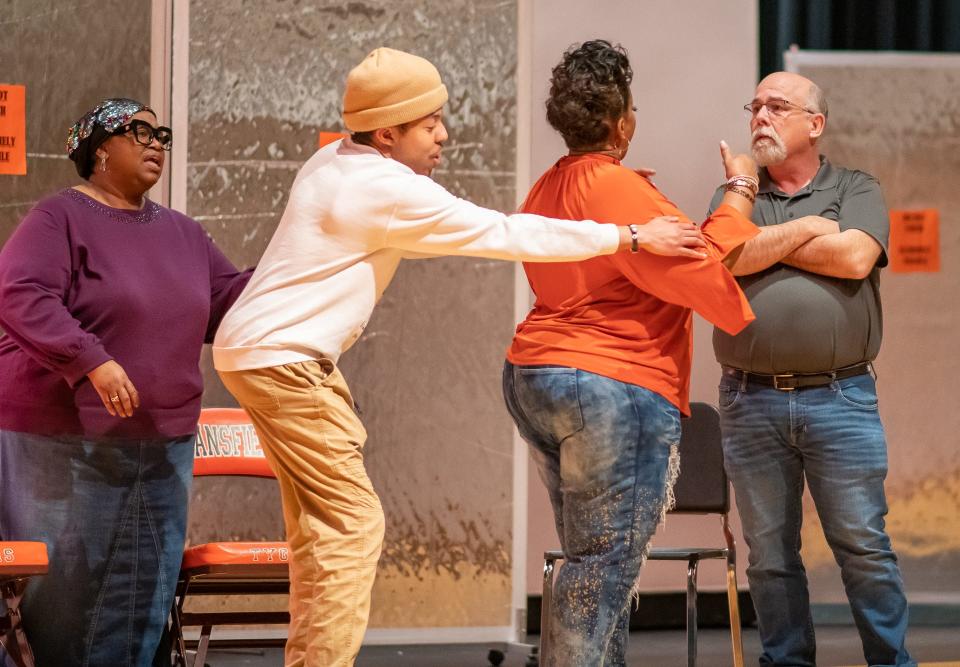 Jody Odom, with hat, tries to hold back Teresa James from going after Carl Hunnell as Lisa Brown, far left, looks on during a scene from "The Family Matters."