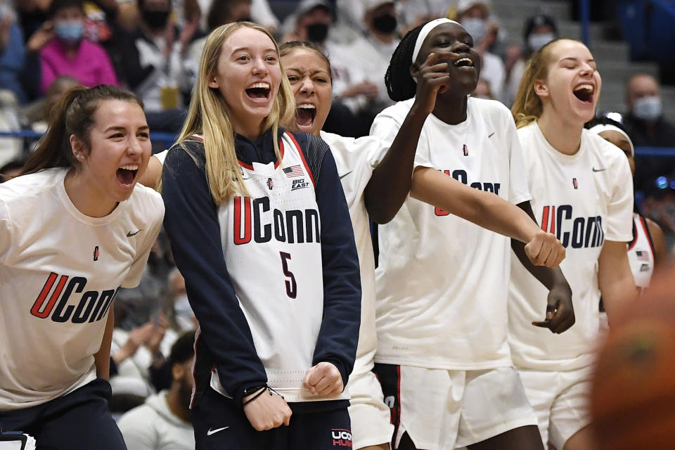 From the left Connecticut's Caroline Ducharme, Paige Bueckers, Amari DeBerry, Piath Gabriel and Dorka Juhász react on the bench in the second half of an NCAA college basketball game against Tennessee, Sunday, Feb. 6, 2022, in Hartford, Conn. (AP Photo/Jessica Hill)