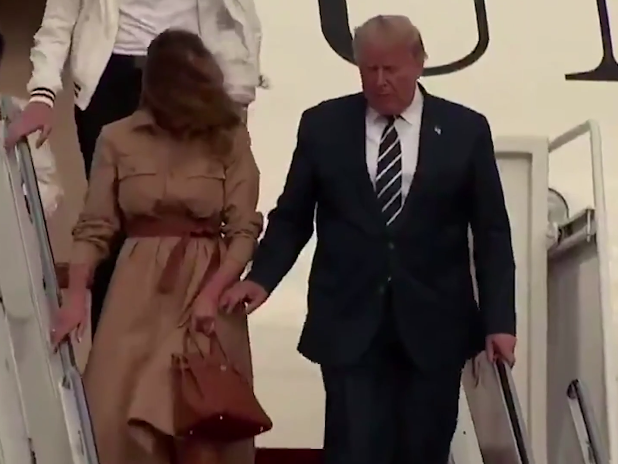 US president Donald Trump attempting to hold the hand of first lady Melania Trump: (Sky News)