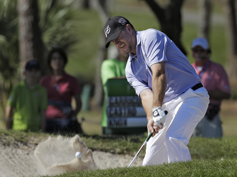 Robert Garrigus blasts from the sand trap on the eighth hole during the second round of the Valspar Championship golf tournament at Innisbrook Friday, March 14, 2014, in Palm Harbor, Fla. (AP Photo/Chris O'Meara)