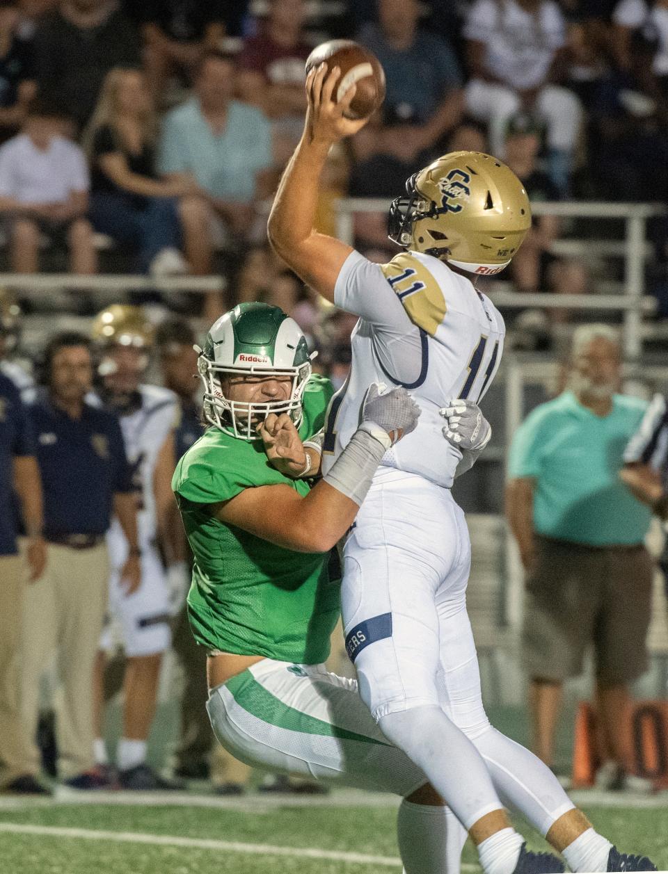 St. Mary's Ryan Gaea, left, sacks Central Catholic quarterback Tyler Wentworth during the so-called "Holy Bowl" varsity football game at St. Mary's Sanguinetti Field in Stockton on Aug. 25, 2023.