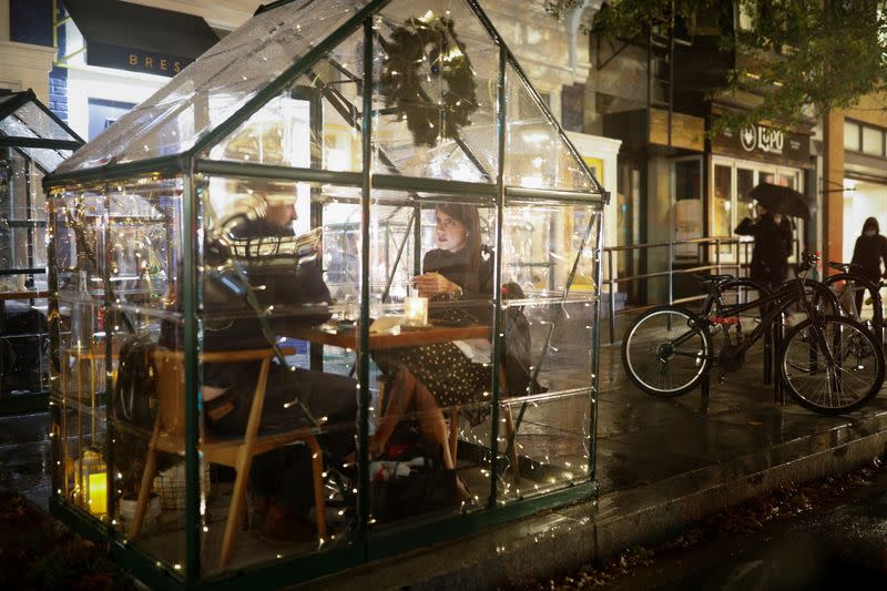 Restaurant patrons sit inside plastic tents amid the coronavirus disease outbreak in Washington