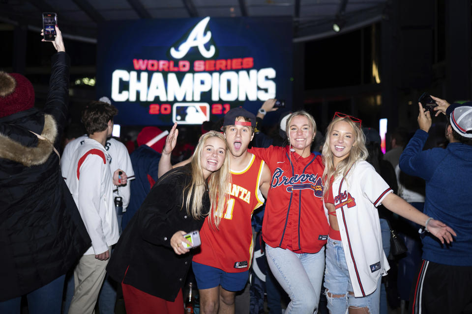 FILE - Atlanta Braves baseball fans celebrate near Truist Park, on, Nov. 2, 2021, in Atlanta. Even if baseball’s first work stoppage in 26 years doesn’t result in missed games, the league and its players are at risk of alienating their next wave of fans. (AP Photo/Rita Harper, File)