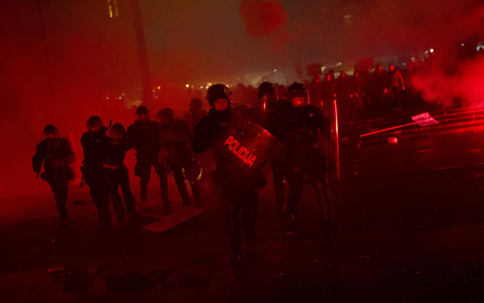 Riot police secure the area as they detain protesters outside the parliament building in Ljubljana, Slovenia, Friday, Nov. 30, 2012. Thousands joined anti-government protests in Slovenia on Friday as tensions soared ahead of this weekend's presidential runoff in the small, economically struggling EU nation. (AP Photo/Matej Leskovsek)