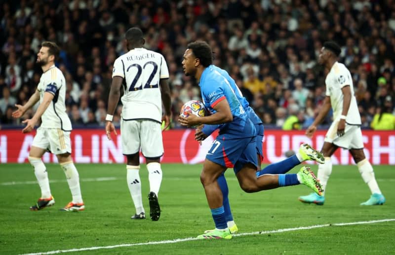 Leipzig's Lois Openda celebrates scoring his side's first goal during the UEFA Champions League round of 16 second leg soccer match between Real Madrid and RB Leipzig at Santiago Bernabeu Stadium. Jan Woitas/dpa