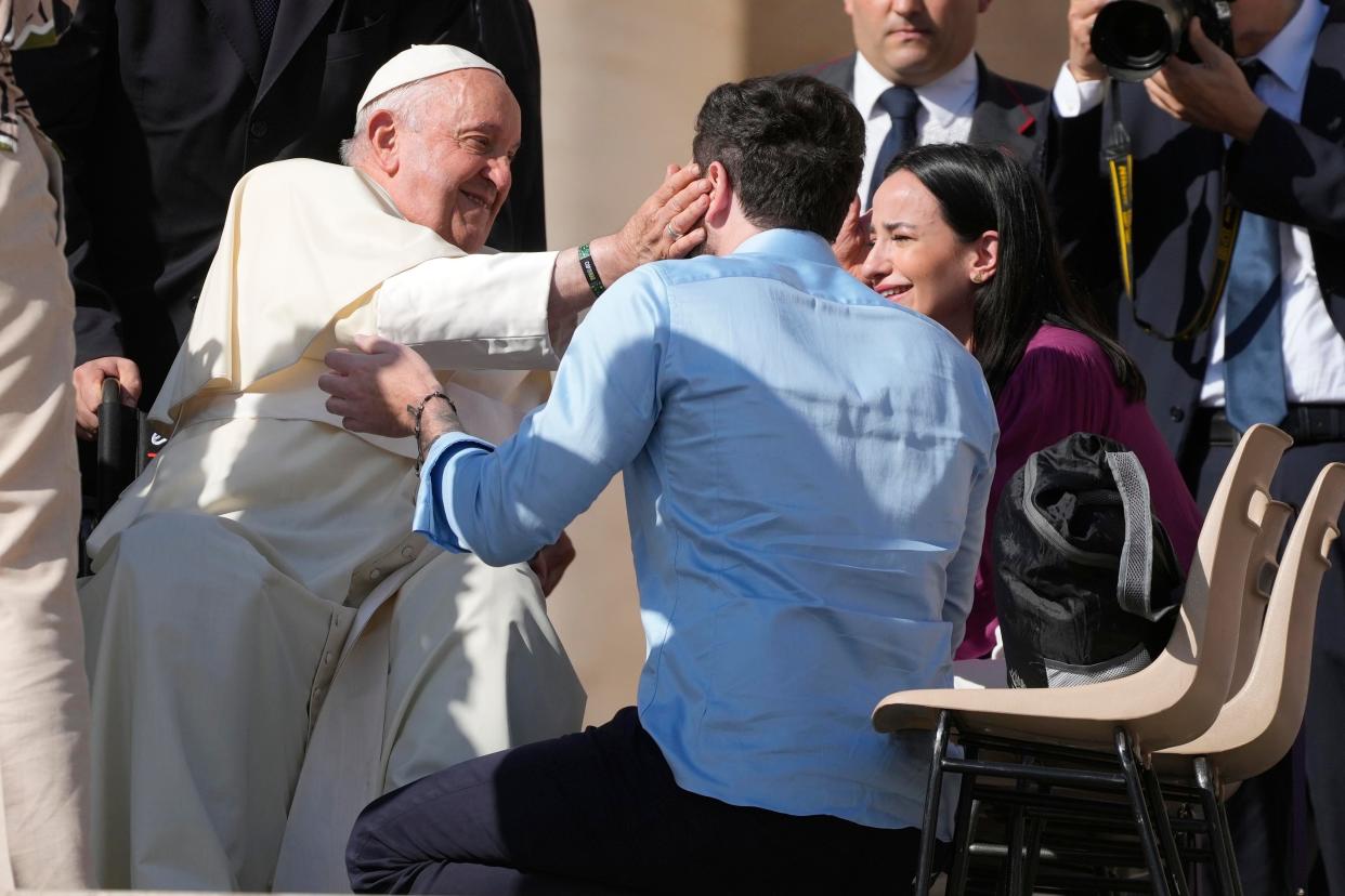 FILE - Newly couples of weds meet with Pope Francis during the weekly general audience in St. Peter's Square at the Vatican, on Oct. 11, 2023. Pope Francis has formally approved allowing priests to bless same-sex couples, with a new document released Monday Dec. 18, 2023 explaining a radical change in Vatican policy by insisting that people seeking God’s love and mercy shouldn’t be subject to “an exhaustive moral analysis” to receive it. (AP Photo/Gregorio Borgia, File)