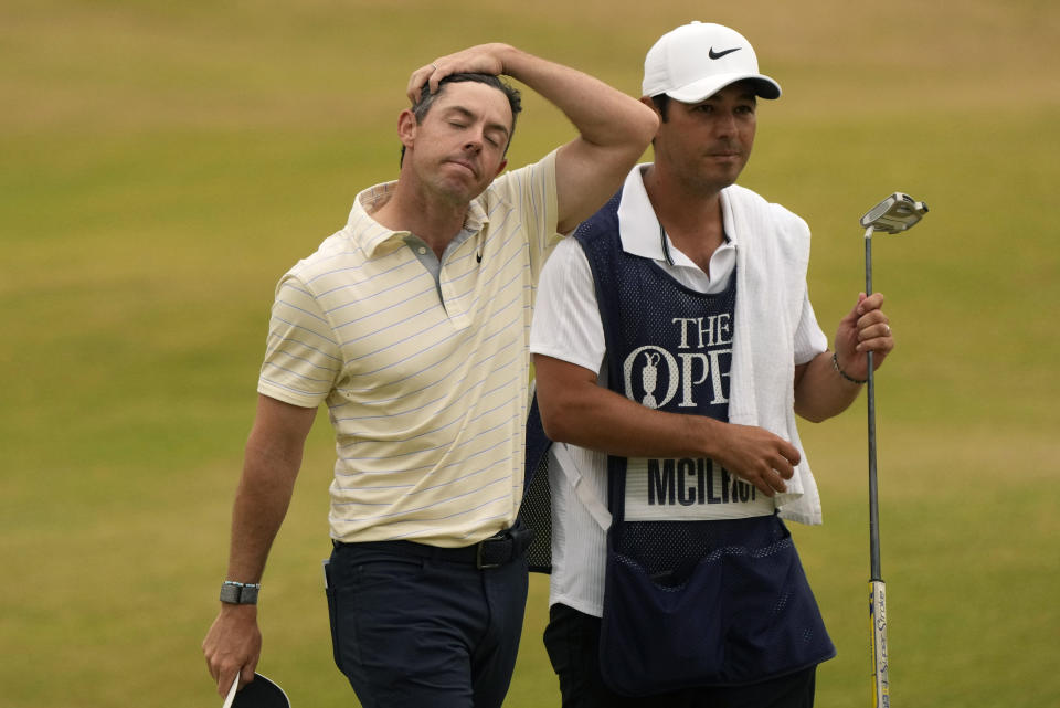 Rory McIlroy of Northern Ireland walk from the 18th green with his caddie after finishing his final round of the British Open golf championship on the Old Course at St. Andrews, Scotland, Sunday July 17, 2022. (AP Photo/Gerald Herbert)