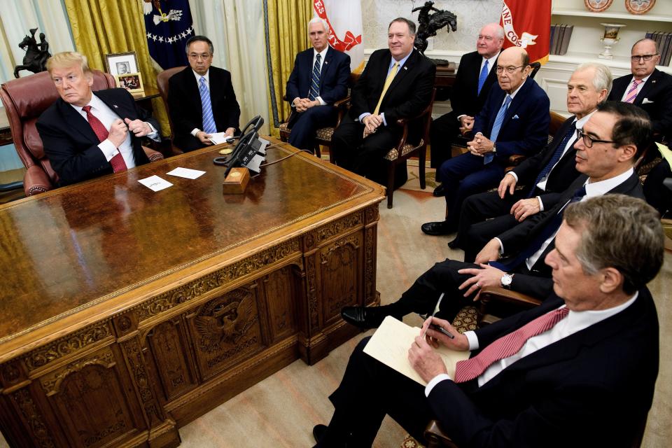 US President Donald Trump (L) waits with US Vice President Mike Pence (3L), US Secretary of State Mike Pompeo (4L), US Secretary of Agriculture Sonny Perdue (5L), US Secretary of Commerce Wilbur Ross (5R), Peter Navarro (4R), US Trade Representative Robert Lighthizer (3R), US Secretary of the Treasury Steven Mnuchin (2R), National Economic Council Director Larry Kudlow (R) and others for a meeting with China's Vice Premier Liu He and other Chinese officials in the Oval Office of the White House January 31, 2019 in Washington, DC. (Photo by Brendan Smialowski / AFP)        (Photo credit should read BRENDAN SMIALOWSKI/AFP/Getty Images)